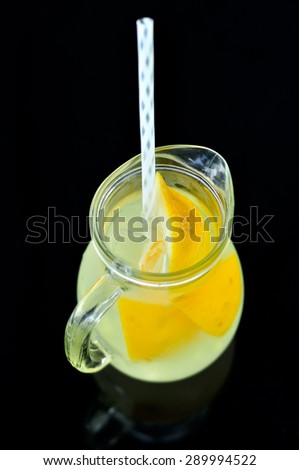Fresh natural lemonade on black background