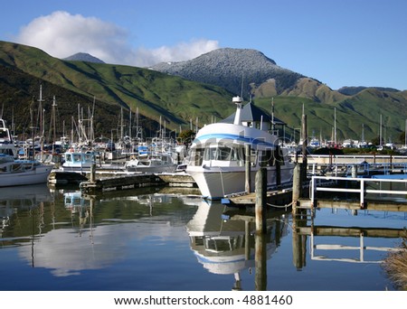 A collection of boats. South Island New Zealand. Frost covered hills in the background.