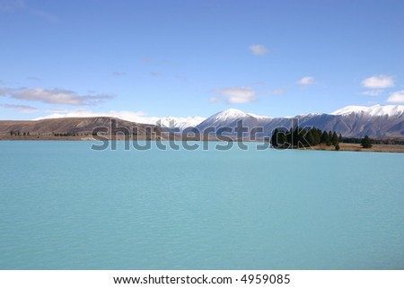 Lake Pukaki - South Island New Zealand. Strange blue colored lake. Snow covered New Zealand Alps in the background