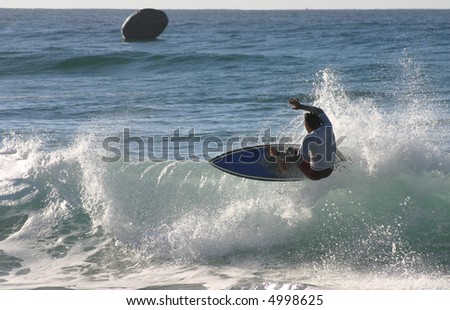 A surfer floats of the lip on a right hand wave. Newcastle Australia.