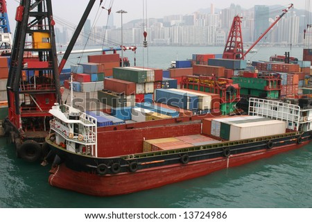 A barge being loaded with containers at a container terminal in Victoria Harbour - Hong Kong