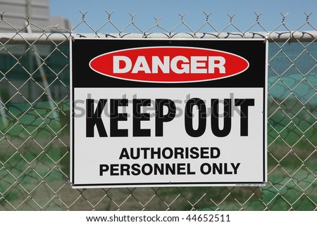 Danger keep out sign on a chain wire fence