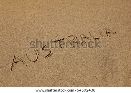 Australia drawn in the sand at the beach on an angle.  Australia's beaches are one of its iconic drawcards.