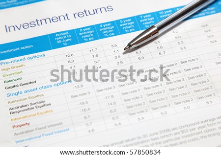 An investment returns statement with ball point pen. Note shallow depth of field, focus on ball point pen.