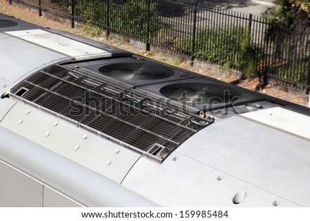 A detail shot of a air-conditioner unit on a urban train