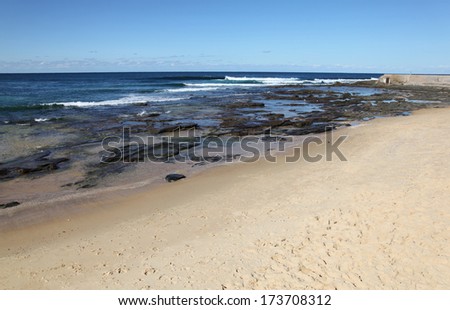 A lovely day on the beach at the Cowrie Hole adjacent to Newcastle Beach Australia. Newcastle is Australia\'s second oldest city and its innner city beaches are one of its drawcards.