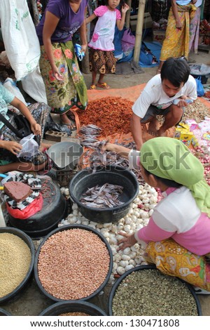 KUTA LOMBOK, INDONESIA - JULY 22 : A woman is selling produce to local customers at Kuta Lombok\'s sunday food market on July 22 2012. The traditional market attracts many from around Kuta Lombok.