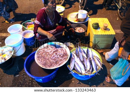 BANYUWANGI, INDONESIA, JULY 7 : Local producers are selling their produce, fruits, fish and chilies at the traditional night market on July 7 2012.