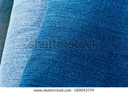 Pile of jeans of various shades of blue