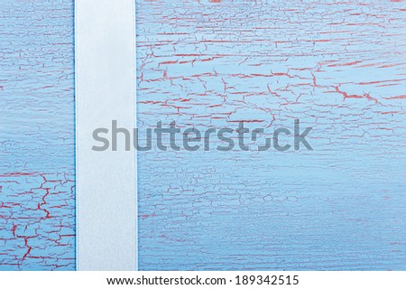 Blue ribbon on shabby blue red background