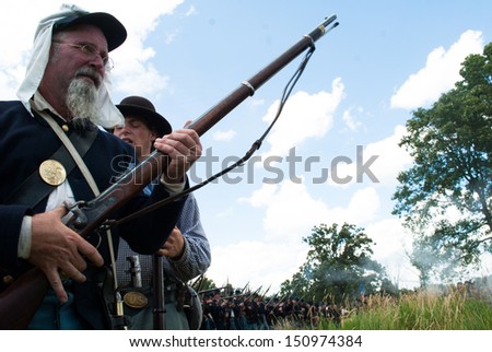 GETTYSBURG, PENNSYLVANIA- JULY 6: A Union reenactor gets ready to fire his Springfield rifle during the second day of the Reenactment of the 150th Anniversary of the Battle of Gettysburg in 2013.