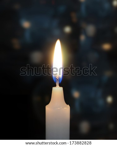 Burning candles on black blue background