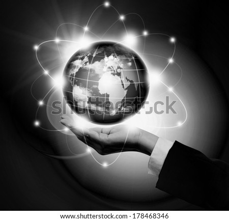 Man holding a glowing earth globe in his hands.Black and White