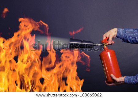 man with extinguisher fighting a fire