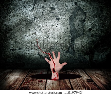 Human hand in the blood runs out of the hole in the wooden floor for help.