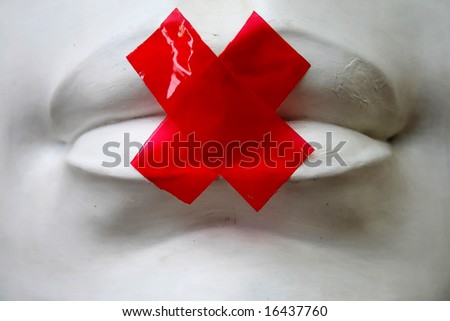 The image of the lips which have been stuck together by a sticky tape.