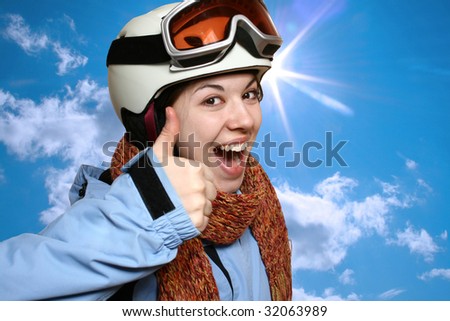 Portrait of the cheerful skier on a background of the blue sky.