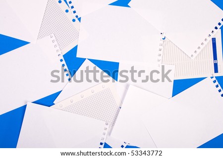 Pure sheets of a paper are scattered on a blue surface.