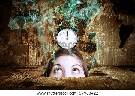 A head of the woman with an alarm clock in the thrown interior. Surrealistic composition.