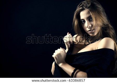 The Attractive woman in black a shirt on a dark background.