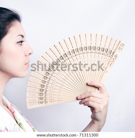 Beautiful Asian woman with a fan in her hand.