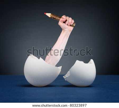 Hand with pencil hatched from eggs. The metaphor of art.
