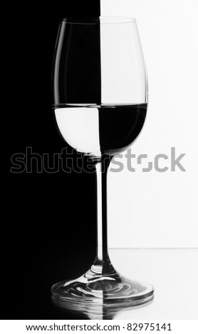 A glass of wine on black and white contrasting background.