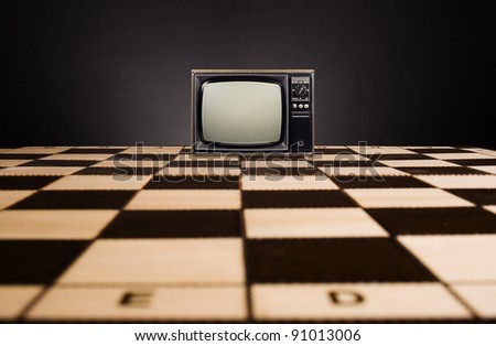 Old TV on the chessboard.