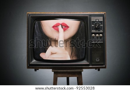Finger a present to the red lips on the screen of the old TV. secret