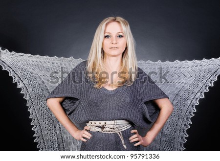 Portrait of a pretty woman in a gray jersey dress