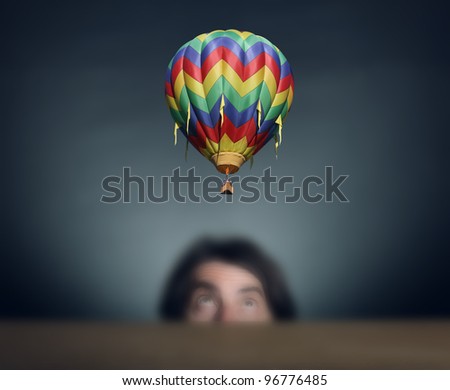 Men\'s head is looking at flying a balloon.