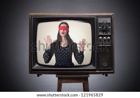 Blindfolded girl on old TV screen.