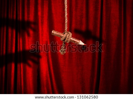 Pencil on a rope and shadow hands reaching for him in the red curtain.
