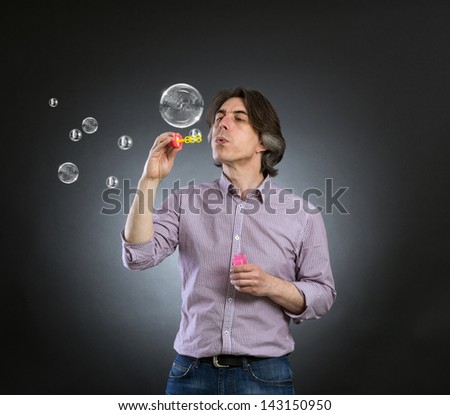 A man inflates soap bubbles.
