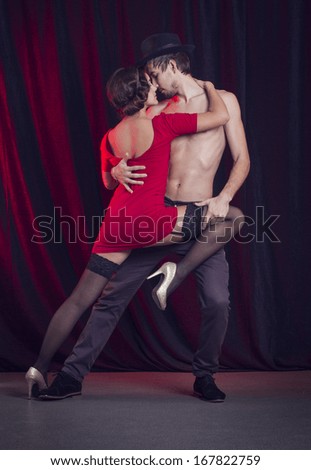 man and a woman in the most romantic dance: tango.