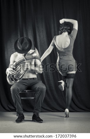 Man playing the trumpet, and a woman dancing. Retro style.