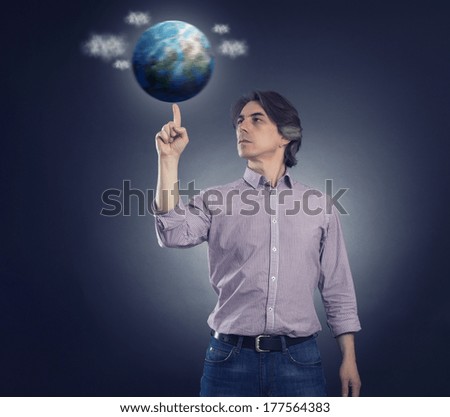 Man spinning on the finger of the planet earth.