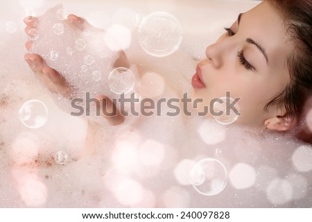 Beautiful woman in bathroom. Female in bath with foam