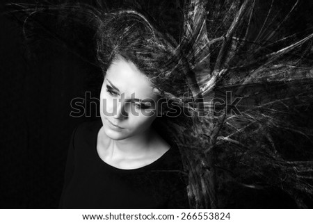 Portrait of a young woman with the effect of double exposure.