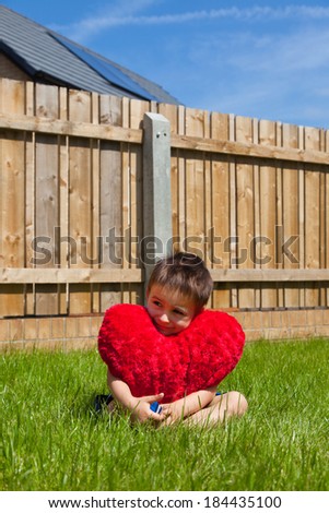 Boy hugging heart