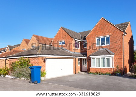 Red brick detached house with garage