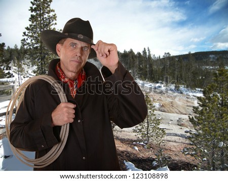 Cowboy with lariat against a winter background