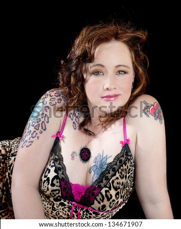 Beautiful sexy women with golden brown eyes wearing leopard print with tattoos on her