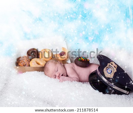 baby sleeping next to a box of donuts next to a police hat with a donut on his back against clouds and stars