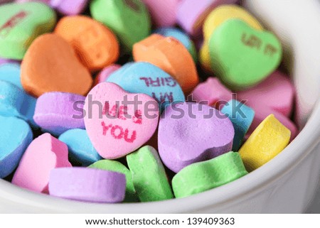 Valentines Day candy hearts in a white bowl