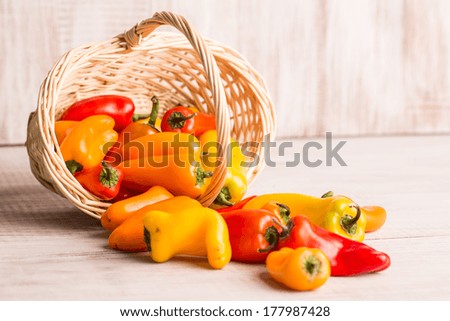 Peppers spilling out of wicker basket