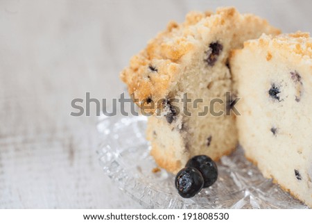 Close up of blueberry muffin cut in half on glass plate