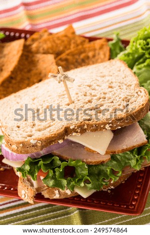 Lunch healthy sandwich with turkey ham and swiss cheese on wheat bread with chips