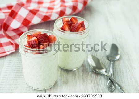 Fresh cups of yogurt for breakfast with strawberries fruit