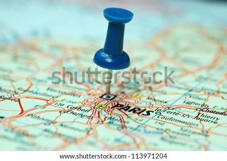 push pin stuck on a map centred on the city of Paris, Capital of the art world